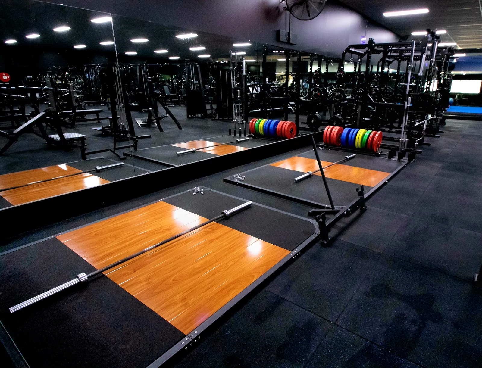 NXT GEN lifting platforms and racks in a commercial gym